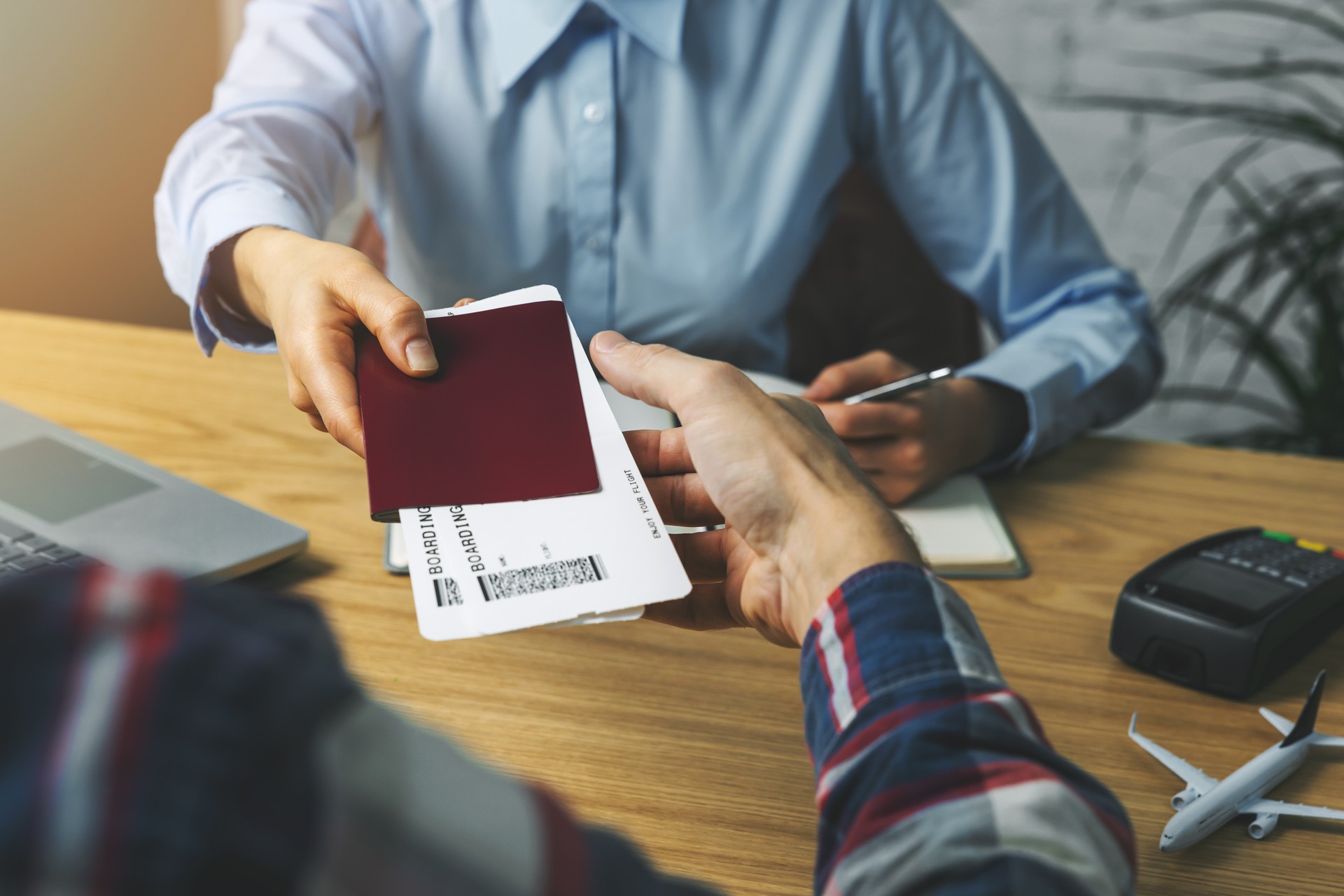 travel agent giving flight tickets and documents to customer in agency office